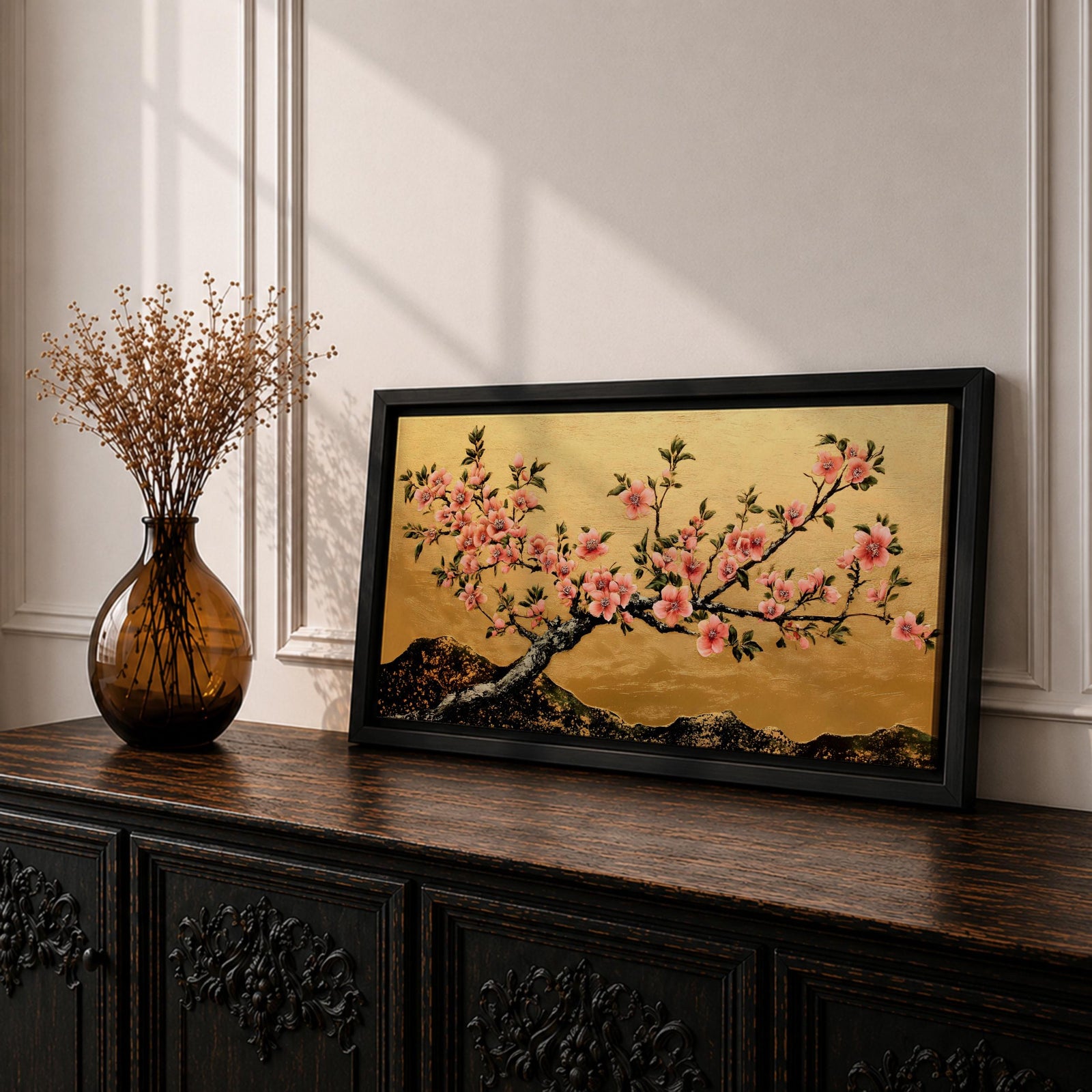A panoramic painting of a flowering cherry blossom branch extending across the composition with clusters of soft pink sakura flowers and dark textured bark, set against a rich gold background with distant mountain silhouettes, rendered in a Japanese inspired style with detailed petals and balanced horizontal composition.
