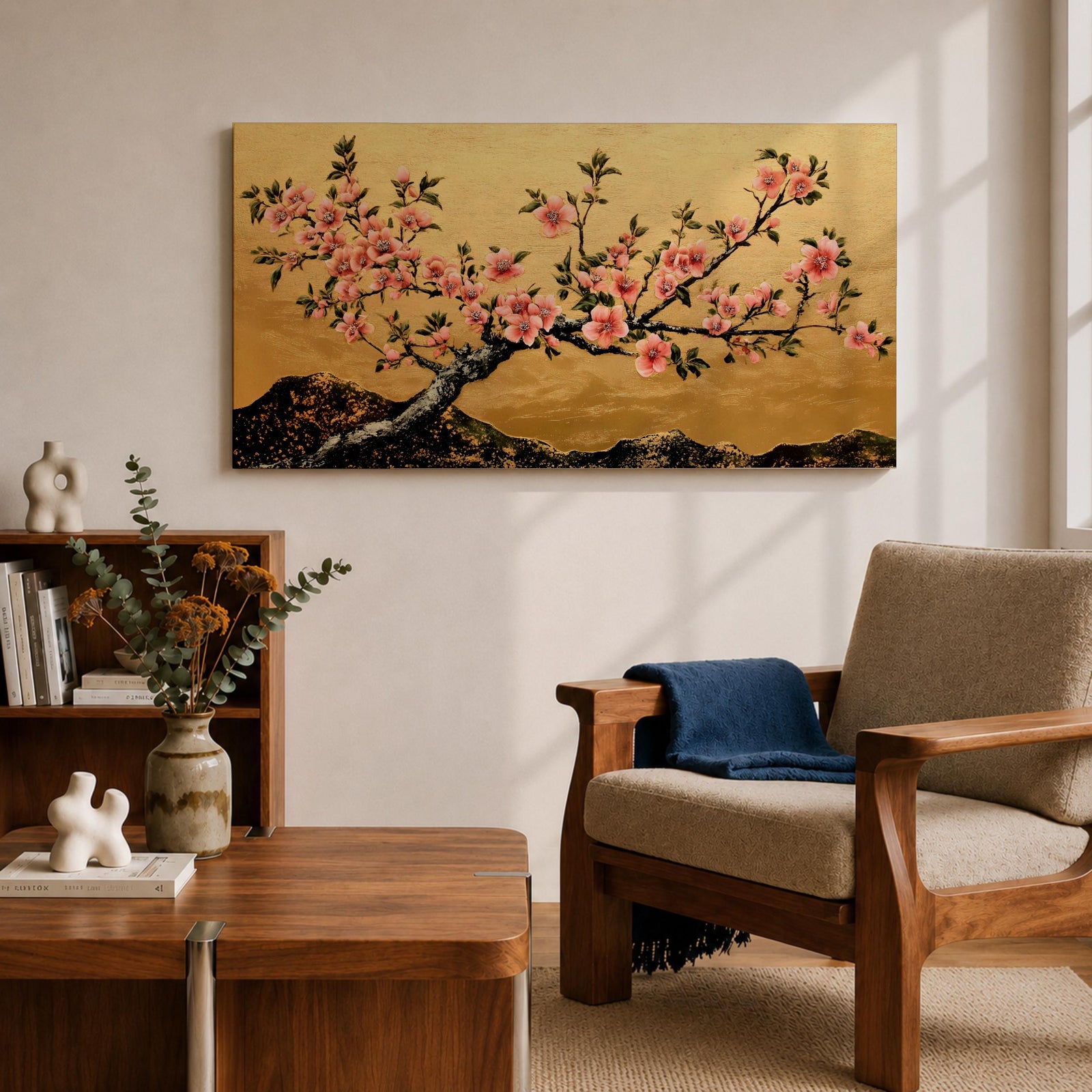 A panoramic painting of a flowering cherry blossom branch extending across the composition with clusters of soft pink sakura flowers and dark textured bark, set against a rich gold background with distant mountain silhouettes, rendered in a Japanese inspired style with detailed petals and balanced horizontal composition.