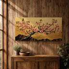 A panoramic painting of a flowering cherry blossom branch extending across the composition with clusters of soft pink sakura flowers and dark textured bark, set against a rich gold background with distant mountain silhouettes, rendered in a Japanese inspired style with detailed petals and balanced horizontal composition.