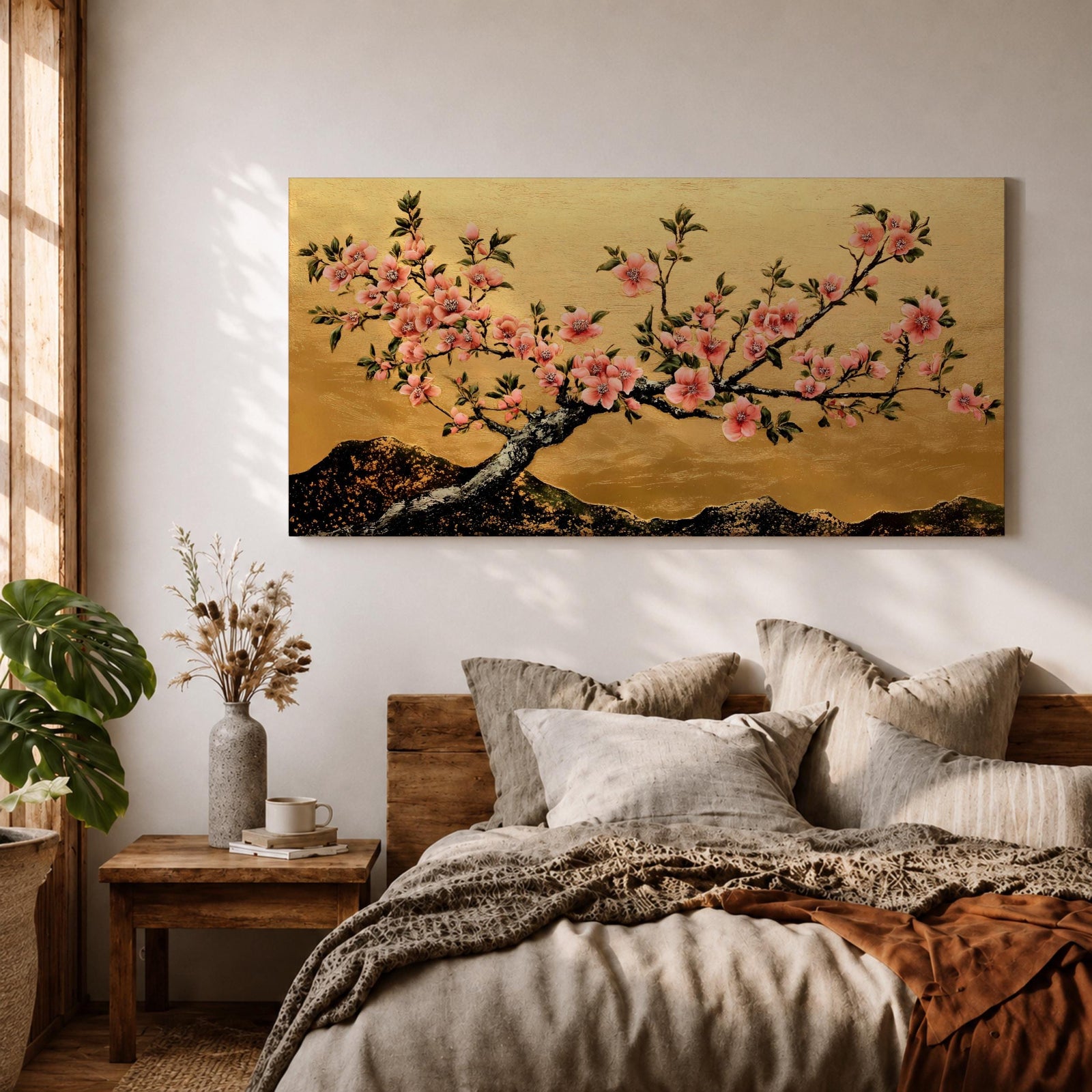 A panoramic painting of a flowering cherry blossom branch extending across the composition with clusters of soft pink sakura flowers and dark textured bark, set against a rich gold background with distant mountain silhouettes, rendered in a Japanese inspired style with detailed petals and balanced horizontal composition.