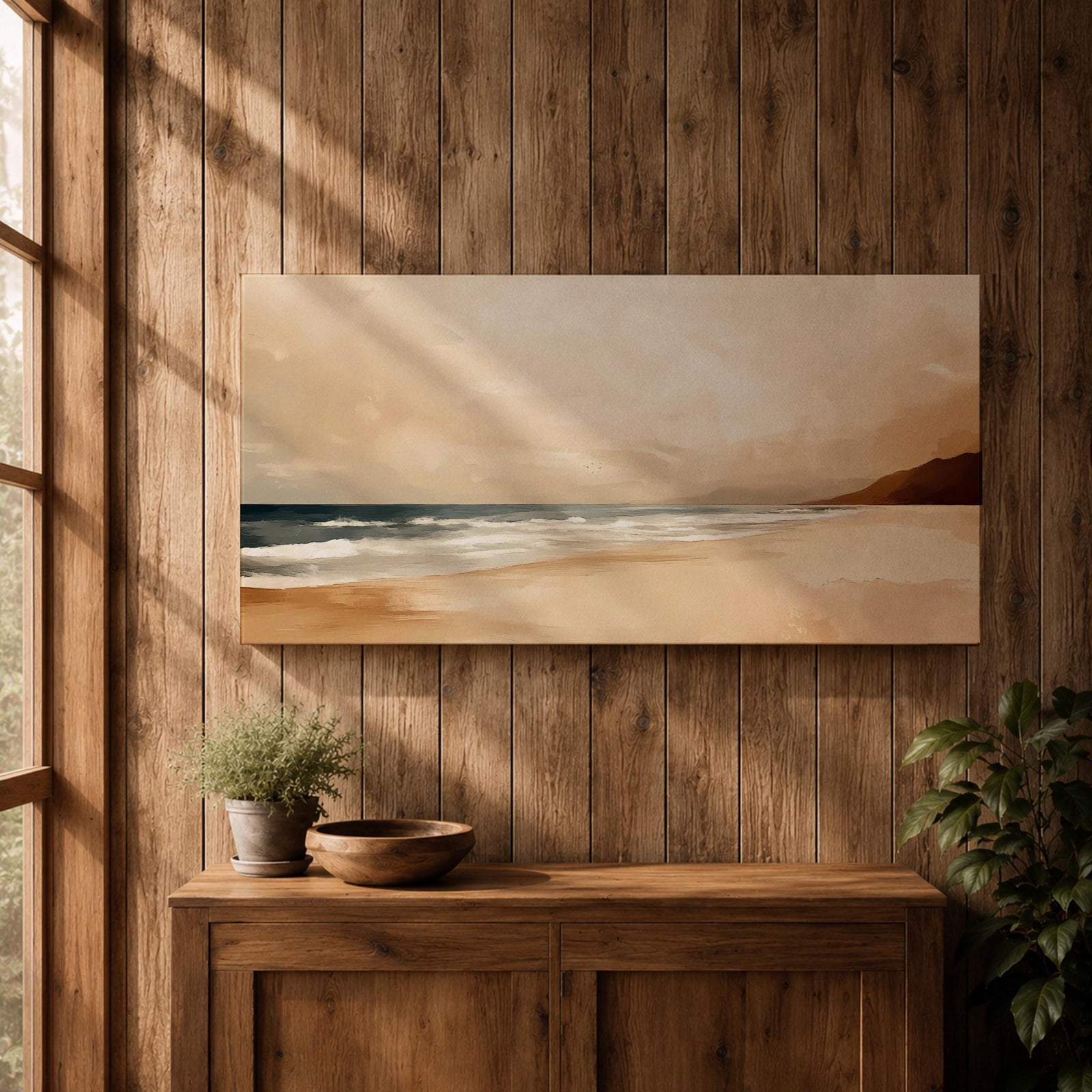 Panoramic coastal landscape painting showing a quiet sandy beach with gentle ocean waves rolling onto the shore beneath a soft sky. Subtle tones of beige, blue, and warm gray create a calm atmosphere while distant hills stretch along the horizon and light reflects across the water.