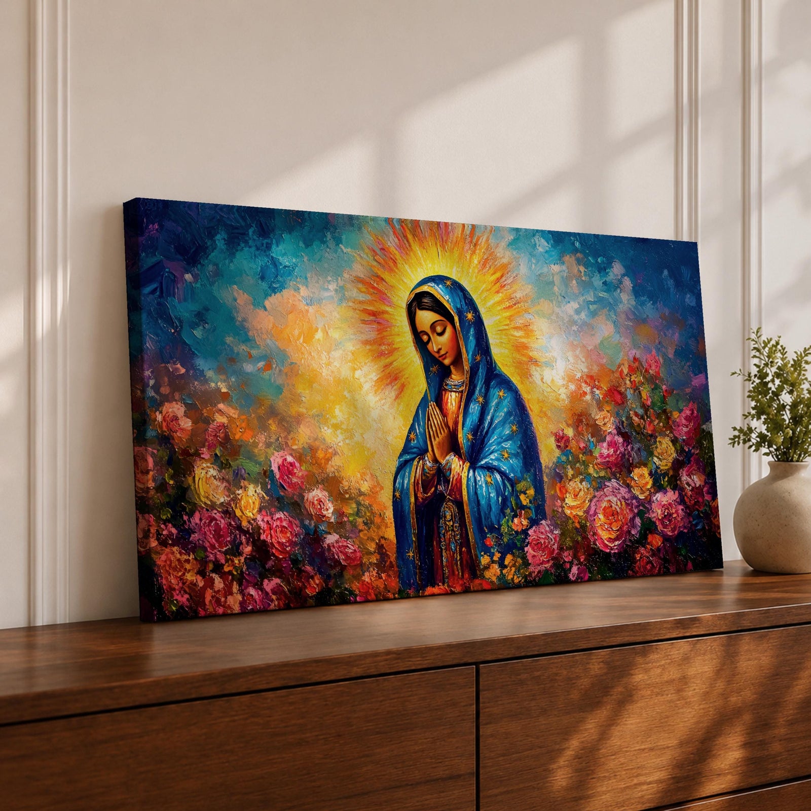 Panoramic painting of the Virgin Mary with hands clasped in prayer wearing a deep blue mantle decorated with golden stars and surrounded by vibrant blooming roses. A radiant golden halo glows behind her head while expressive brushstrokes form colorful clouds and flowers creating a wide devotional religious composition.