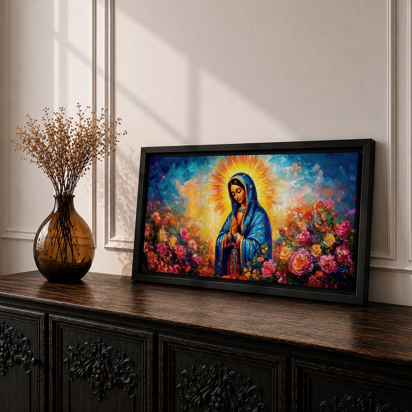 Panoramic painting of the Virgin Mary with hands clasped in prayer wearing a deep blue mantle decorated with golden stars and surrounded by vibrant blooming roses. A radiant golden halo glows behind her head while expressive brushstrokes form colorful clouds and flowers creating a wide devotional religious composition.