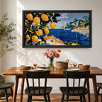 Panoramic painting of bright yellow lemons hanging from leafy branches overlooking the Amalfi Coast with deep blue Mediterranean water, sailboats, and a hillside Italian village with terracotta roofs beneath rugged mountains. Thick palette knife brushstrokes create textured citrus fruit foliage and coastal architecture in a wide landscape composition.