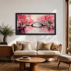 Panoramic painting of blooming cherry blossom trees with soft pink petals surrounding a curved bridge over calm water during spring. Layers of textured brushstrokes form clusters of blossoms drifting across the scene while reflections shimmer on the surface creating a wide Japanese inspired spring landscape composition.