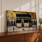 Panoramic gold and black painting of the Kaaba at Masjid al Haram in Mecca, showing the cubed sanctuary draped in the black kiswah with gold calligraphy bands. Surrounding mosque arches and marble courtyard stretch across the horizontal composition while small pilgrim figures circle the Kaaba creating scale and depth.