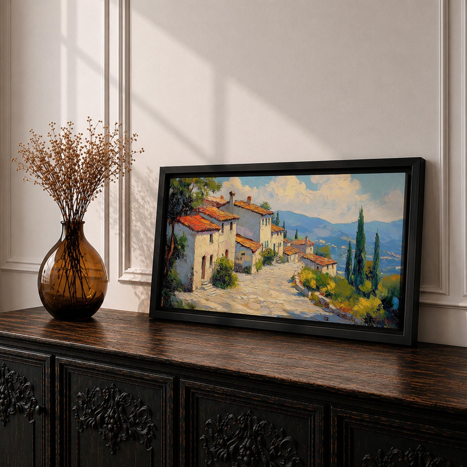 Panoramic painting of a Mediterranean hillside village with warm stone houses and terracotta roofs overlooking the rolling Tuscany hills. Thick palette knife brushstrokes create textured buildings cypress trees and layered green landscapes beneath a glowing sky forming a wide Italian countryside scene.
