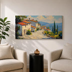 Panoramic painting of a Mediterranean hillside village with warm stone houses and terracotta roofs overlooking the rolling Tuscany hills. Thick palette knife brushstrokes create textured buildings cypress trees and layered green landscapes beneath a glowing sky forming a wide Italian countryside scene.