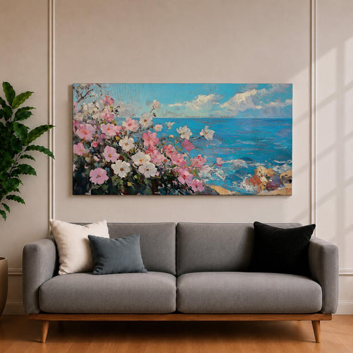 Panoramic painting of pink and white cosmos flowers blooming along a coastal cliff with vibrant blue ocean waves stretching toward the horizon beneath soft clouds. Thick palette knife brushstrokes create textured petals foliage and rocky shoreline forming a wide horizontal seaside landscape filled with bright floral color and movement.
