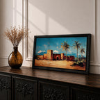 Panoramic painting of a Moroccan kasbah built from warm earthen walls set in a desert landscape with tall palm trees and distant snow capped mountains beneath a bright blue sky. Thick palette knife textures shape the fortress architecture sandy ground and foliage creating a wide horizontal North African landscape scene with bold contrast.