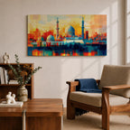 Panoramic abstract painting of Al Masjid an Nabawi in Medina featuring the mosque domes and tall minarets with the iconic green dome at the center. The architecture is rendered with geometric block brushstrokes in vibrant blues, reds, yellows and oranges creating a modern cityscape style composition.
