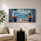 A panoramic painting of a Mediterranean seaside village viewed through a stone arch window, featuring blue ocean waters, sailboats, terracotta rooftops, and vibrant floral pots.