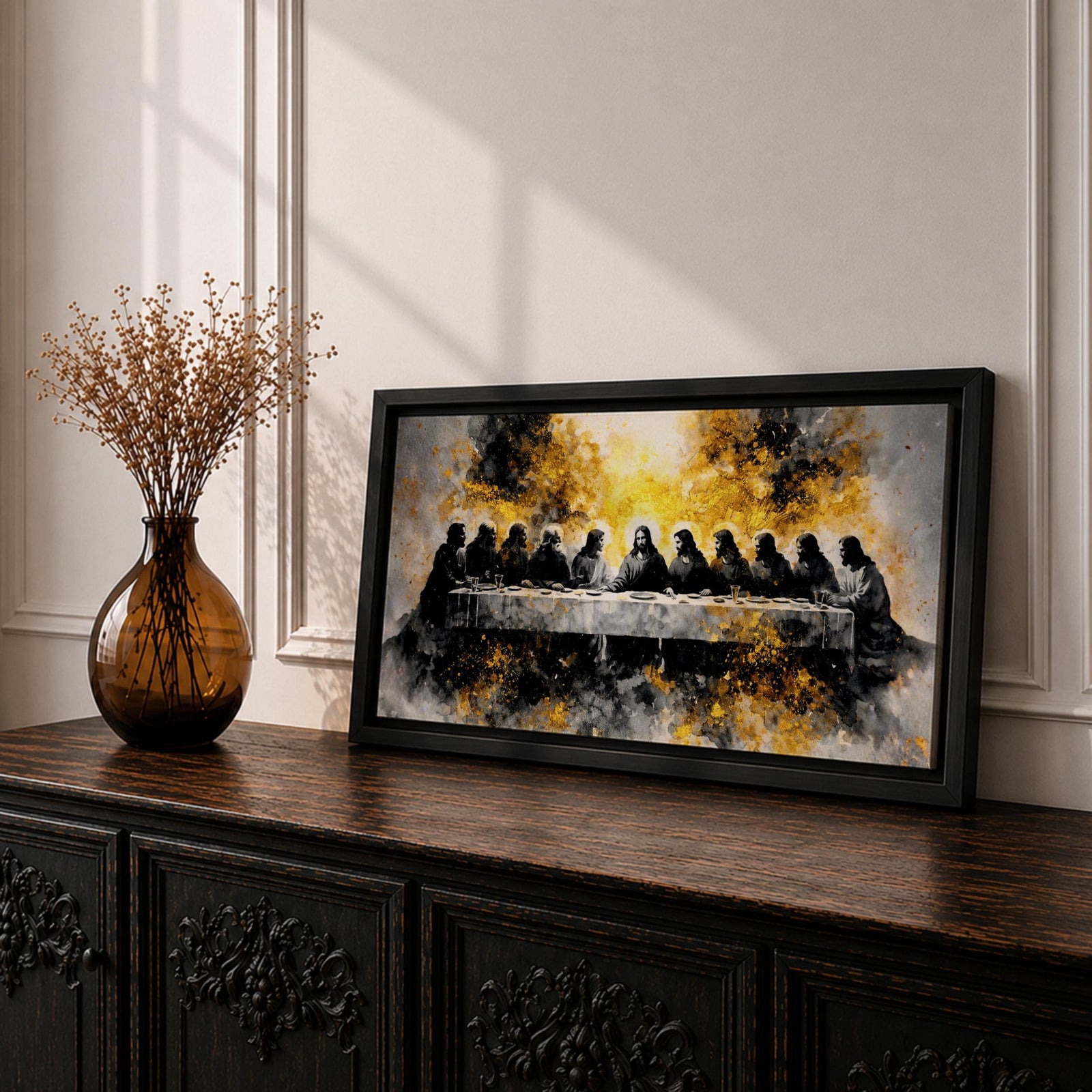 A dramatic panoramic interpretation of the Last Supper showing Jesus seated at the center with his apostles along a long table, rendered in a monochrome palette with striking gold accents and a radiant glowing aura behind Christ, creating a powerful and modern spiritual composition.
