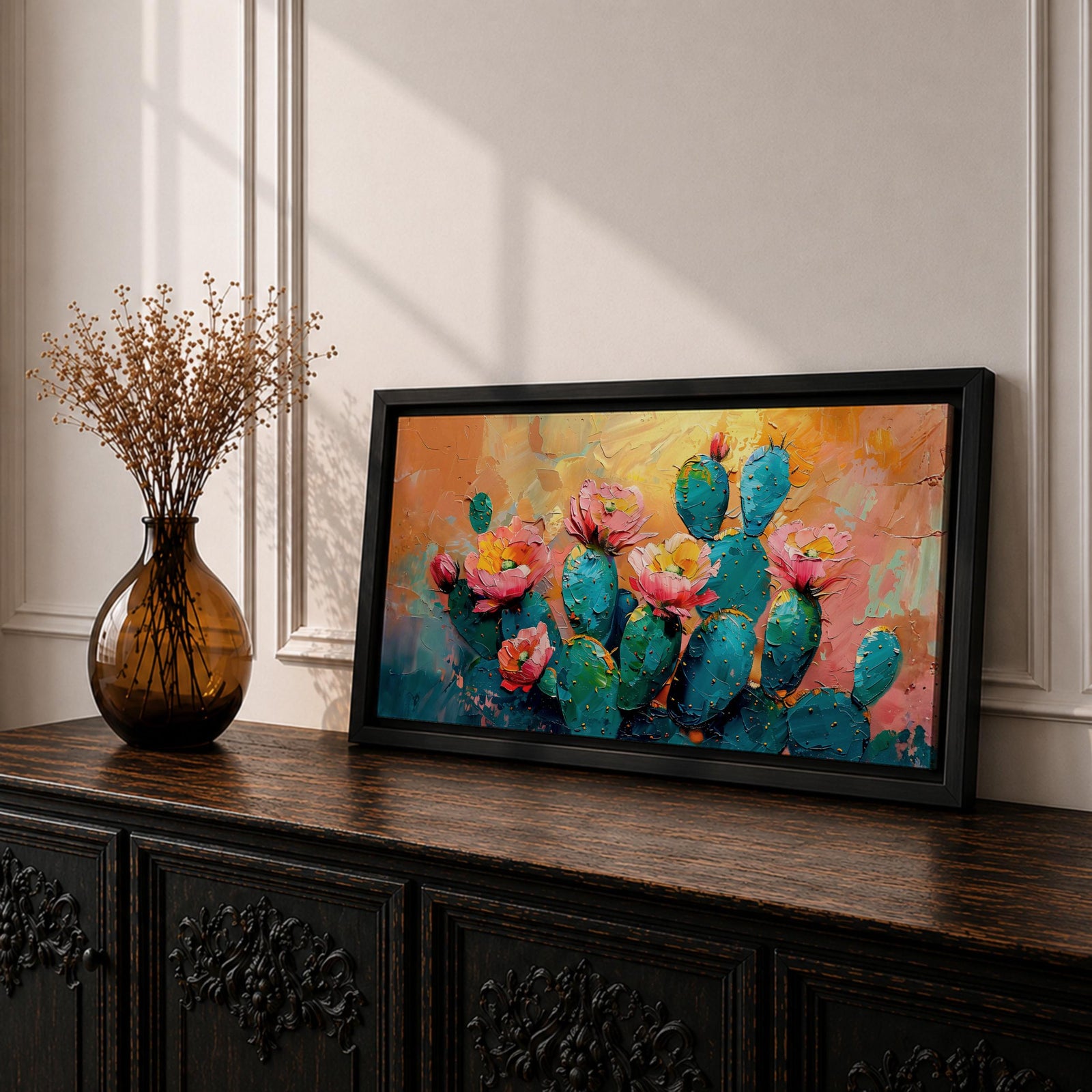 A panoramic textured painting of prickly pear cactus pads in rich teal tones adorned with blooming pink and coral flowers, set against a warm abstract desert background of golden orange and soft pastels, rendered with thick brushstrokes that create depth, contrast, and a vibrant southwestern composition.