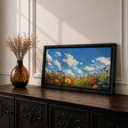 A panoramic painting of a colorful wildflower meadow under a bright blue sky with soft clouds, creating a vibrant and uplifting landscape scene.