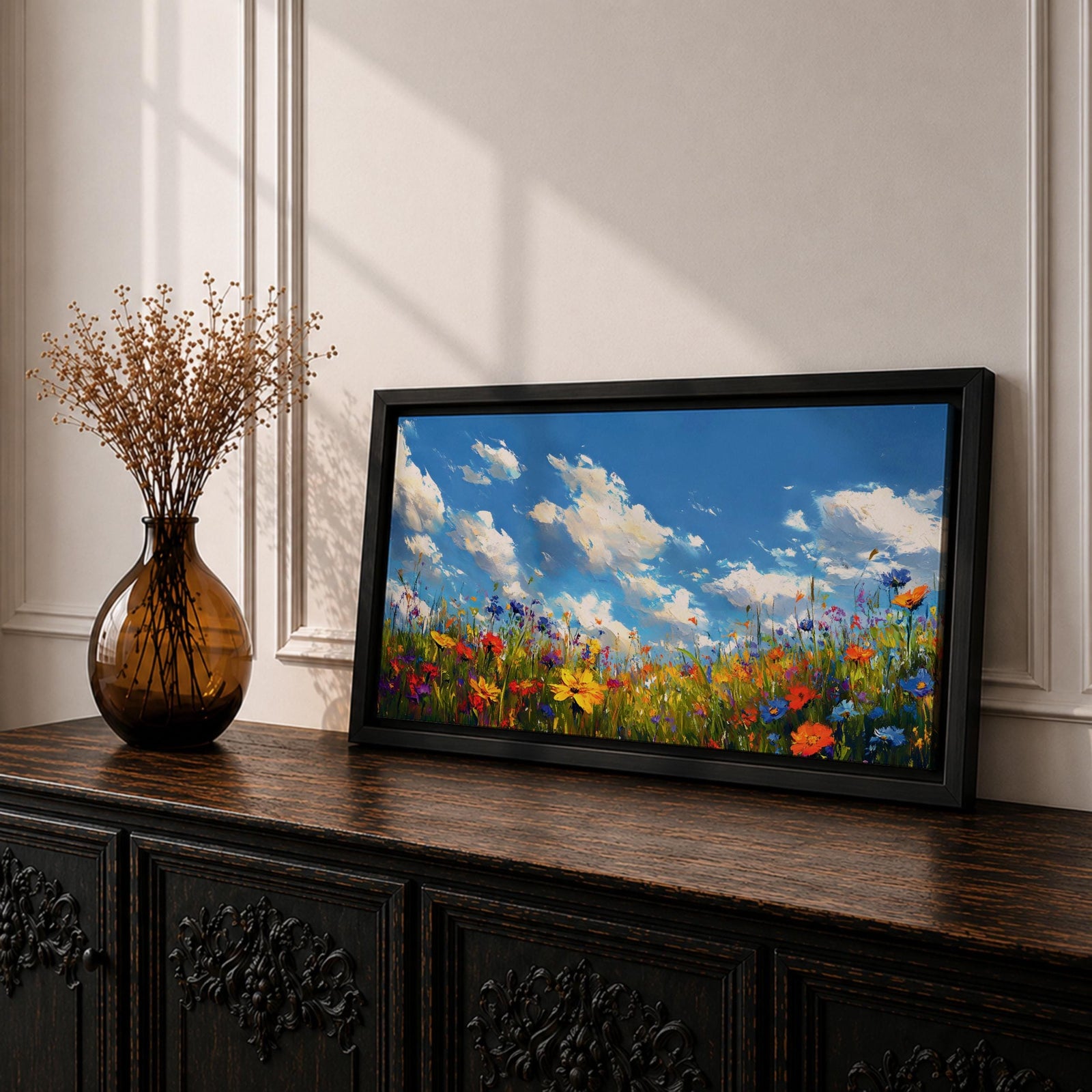 A panoramic painting of a colorful wildflower meadow under a bright blue sky with soft clouds, creating a vibrant and uplifting landscape scene.