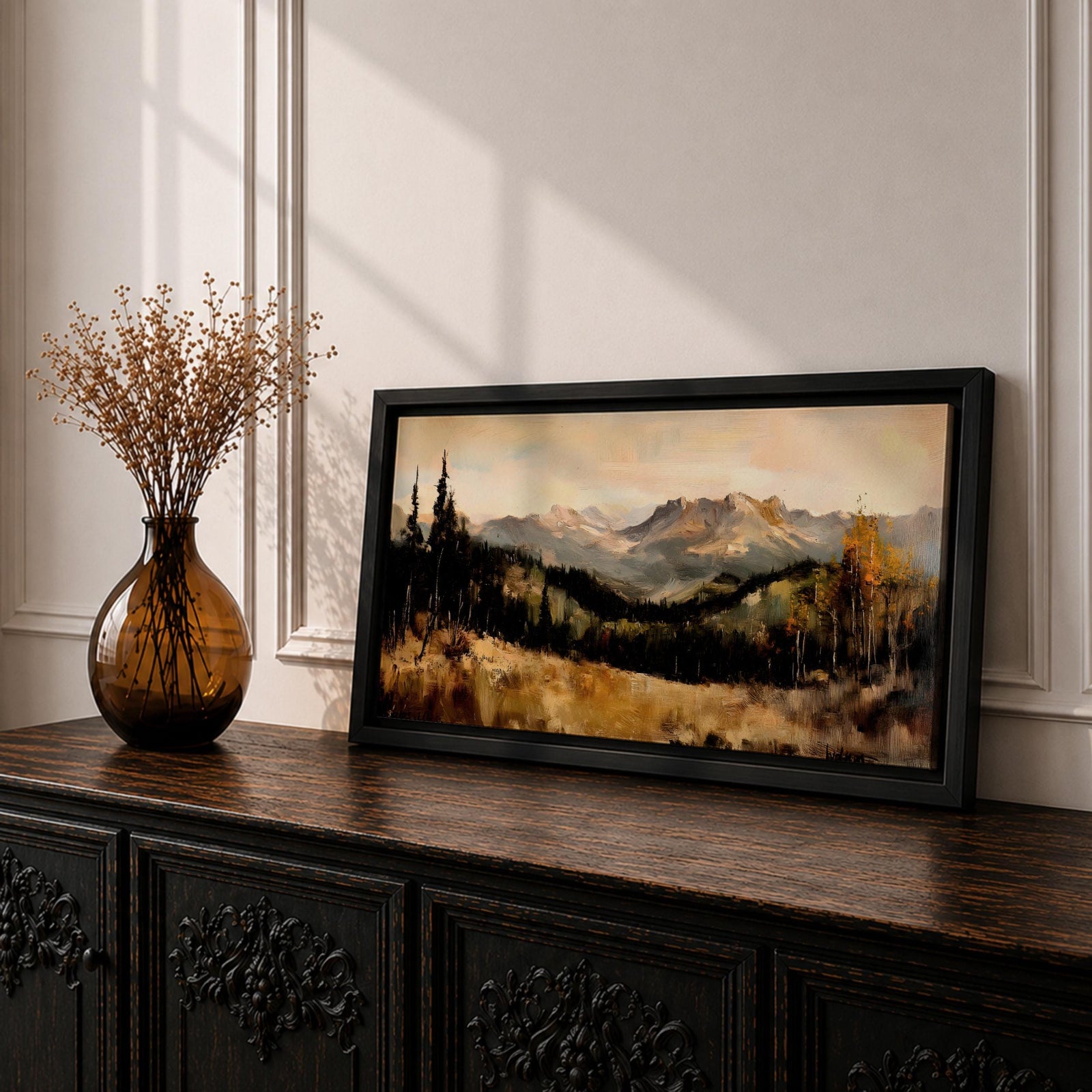A panoramic landscape painting of a serene mountain valley with distant rugged peaks, surrounded by tall evergreen trees and autumn foliage, with a reflective stream or meadow in the foreground, rendered in soft earthy tones and textured brushstrokes that create depth, atmosphere, and a tranquil natural scene.