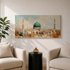 Panoramic abstract painting of Masjid Nabawi in Medina featuring the iconic green dome and two slender minarets rising above arches and mosque courtyards. The artwork uses thick textured brushstrokes in warm sand, gold, and cream tones with turquoise sky accents, highlighting the vibrant green dome in a wide horizontal composition.