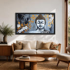 Panoramic painting of a serene Buddha portrait with closed eyes rendered in textured gray and gold tones. The composition features golden leaves and white blossoms surrounding the calm face, with layered brushstrokes and metallic accents creating contrast against a dark abstract background.