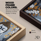Panoramic painting of a serene Buddha portrait with closed eyes rendered in textured gray and gold tones. The composition features golden leaves and white blossoms surrounding the calm face, with layered brushstrokes and metallic accents creating contrast against a dark abstract background.