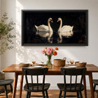Panoramic painting of two white swans facing each other on dark reflective water with graceful curved necks forming a symmetrical composition. The birds glow against a deep black background with shimmering reflections and textured brushstrokes highlighting feathers and light across the calm water surface.