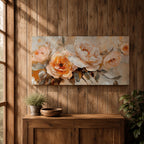 Panoramic floral painting featuring large peach and cream garden style blossoms with layered petals arranged in a soft bouquet composition. Thick textured brushstrokes in warm peach, ivory, and beige tones blend with muted green leaves and a light neutral background creating a wide botanical composition.