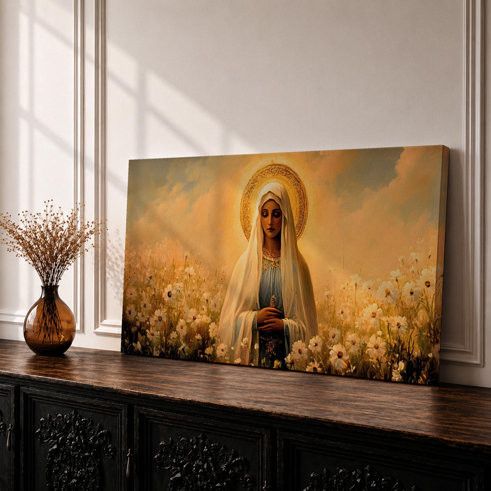Panoramic painting of the Virgin Mary standing in a field of white flowers with a golden halo surrounding her head. She wears a flowing veil and robe while holding her hands gently together. Warm golden sky tones and soft floral details create a serene devotional composition.