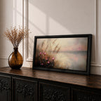 Panoramic landscape painting of soft pink wildflowers and tall grasses growing along a calm lakeshore. The scene features delicate meadow blooms in the foreground with textured brushstrokes and warm earthy tones, fading into a misty reflective lake and distant horizon under a gentle sky.