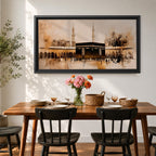 Panoramic painting of the Kaaba at Masjid al Haram in Mecca surrounded by mosque arches and tall minarets. The composition features the black cube structure at the center with pilgrims gathered in the courtyard, rendered in expressive brushstrokes with beige, brown, and gold tones.