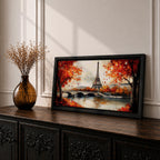 Panoramic painting of the Eiffel Tower rising above the Seine River with an arched stone bridge and classic Parisian buildings along the waterfront. Vibrant red and orange autumn trees frame the scene while textured brushstrokes reflect warm foliage and architecture across the calm river surface.