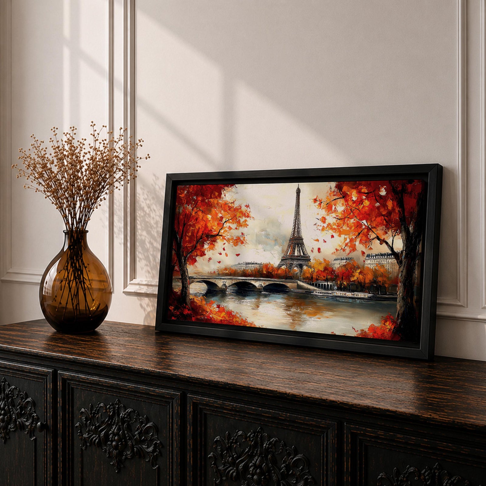 Panoramic painting of the Eiffel Tower rising above the Seine River with an arched stone bridge and classic Parisian buildings along the waterfront. Vibrant red and orange autumn trees frame the scene while textured brushstrokes reflect warm foliage and architecture across the calm river surface.
