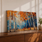 Panoramic painting of tall white birch trees with textured bark standing among vivid orange autumn foliage. Thick palette knife brushstrokes create layered leaves and forest floor tones, with warm golden light filtering through the canopy against cool blue woodland shadows.
