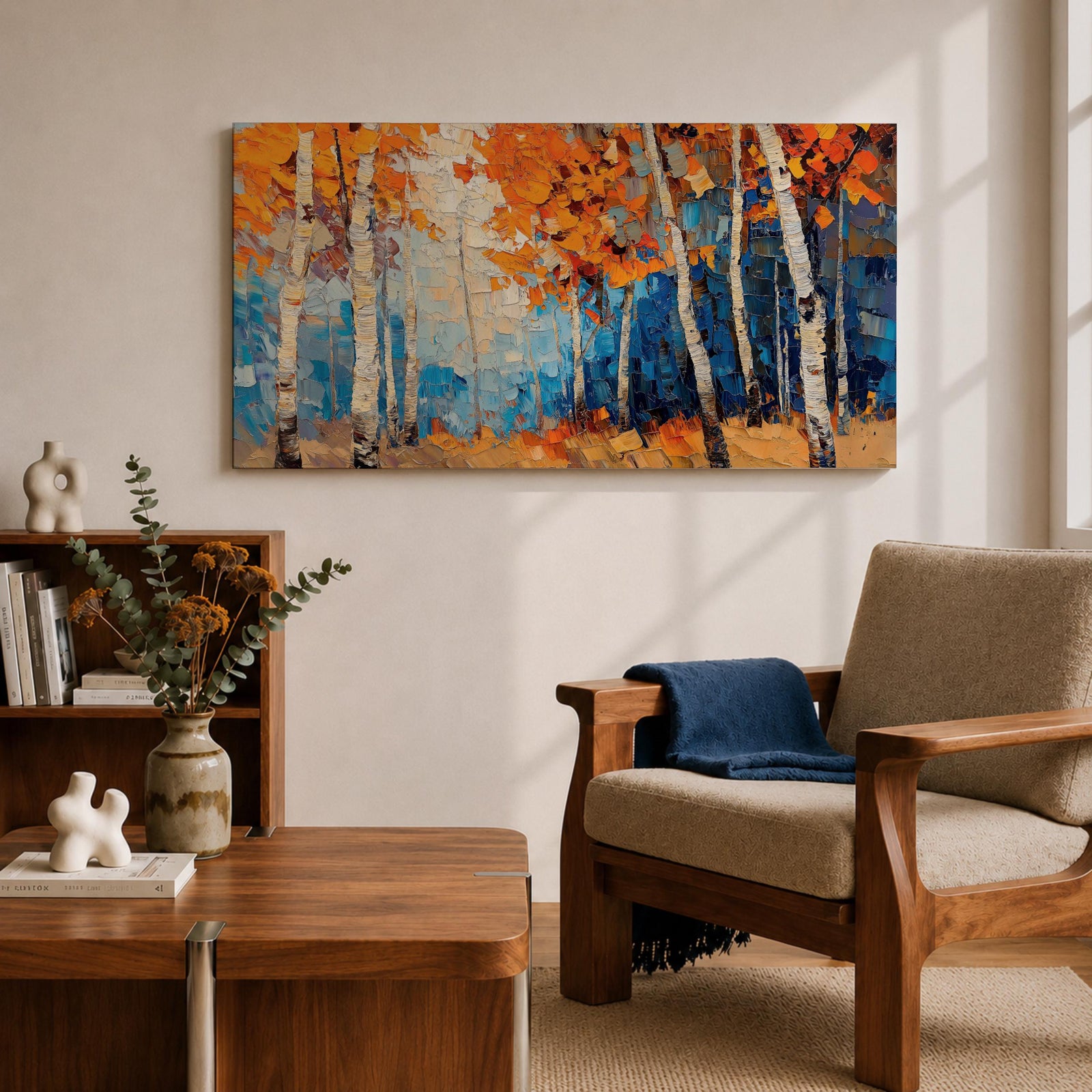 Panoramic painting of tall white birch trees with textured bark standing among vivid orange autumn foliage. Thick palette knife brushstrokes create layered leaves and forest floor tones, with warm golden light filtering through the canopy against cool blue woodland shadows.