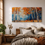 Panoramic painting of tall white birch trees with textured bark standing among vivid orange autumn foliage. Thick palette knife brushstrokes create layered leaves and forest floor tones, with warm golden light filtering through the canopy against cool blue woodland shadows.