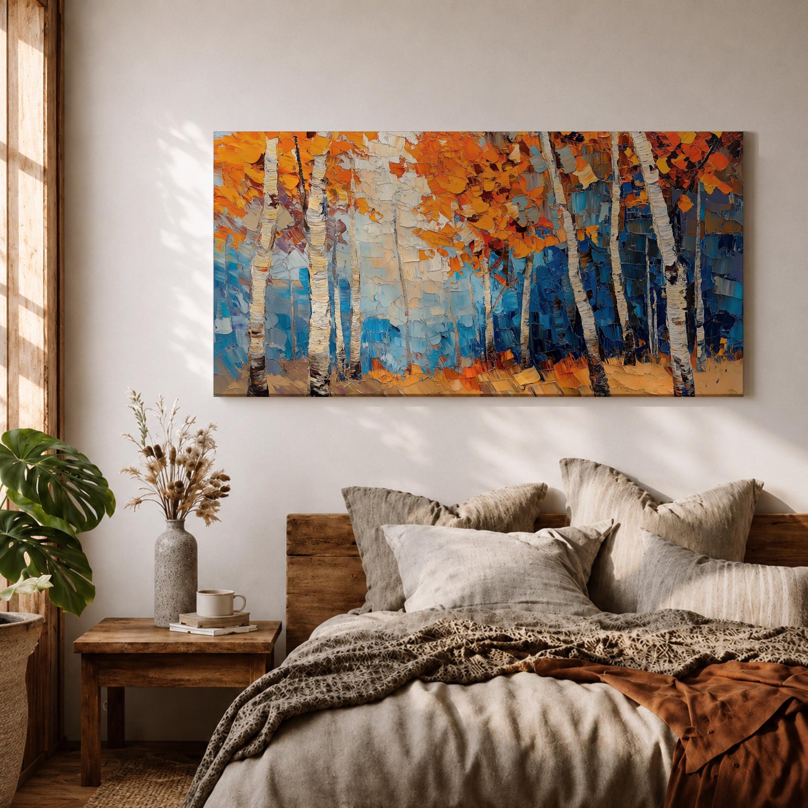 Panoramic painting of tall white birch trees with textured bark standing among vivid orange autumn foliage. Thick palette knife brushstrokes create layered leaves and forest floor tones, with warm golden light filtering through the canopy against cool blue woodland shadows.