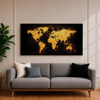 Panoramic artwork of a world map rendered in textured metallic gold against a deep black background. The continents appear with rough painterly edges and splattered gold accents, creating a bold global composition with strong contrast and modern map styling.