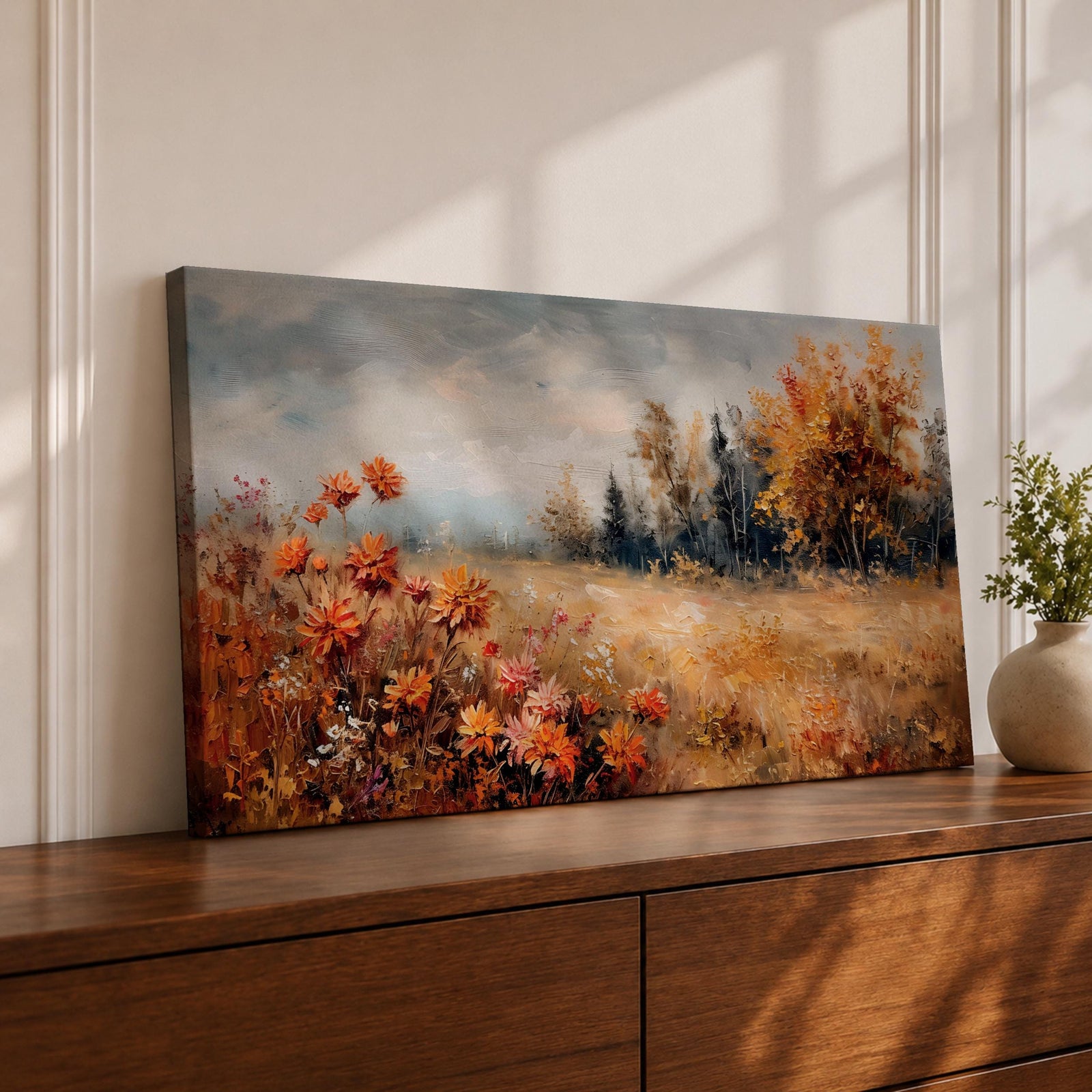Panoramic landscape painting of an autumn meadow filled with orange wildflowers and golden grasses stretching toward a distant treeline. Soft textured brushstrokes depict fall foliage and a muted cloudy sky, creating a warm countryside scene with natural seasonal colors.
