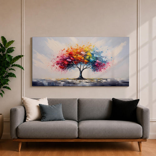 Panoramic abstract painting of a solitary tree with a vibrant multicolored canopy formed by expressive palette knife strokes. Bright red, yellow, blue, and pink leaves burst outward against a soft neutral background while the dark trunk anchors the composition.