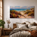 Panoramic coastal landscape painting of sandy beach dunes leading toward turquoise ocean waves under a bright sky. Tall grasses and colorful wildflowers line a winding path through the dunes, painted with loose textured brushstrokes capturing sunlight, sea breeze, and shoreline scenery.