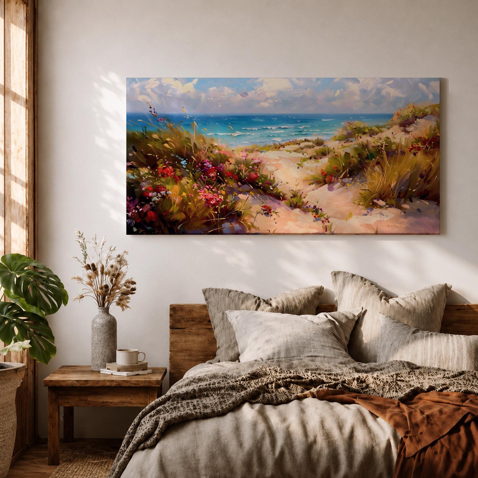 Panoramic coastal landscape painting of sandy beach dunes leading toward turquoise ocean waves under a bright sky. Tall grasses and colorful wildflowers line a winding path through the dunes, painted with loose textured brushstrokes capturing sunlight, sea breeze, and shoreline scenery.