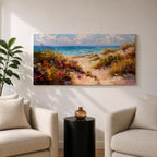 Panoramic coastal landscape painting of sandy beach dunes leading toward turquoise ocean waves under a bright sky. Tall grasses and colorful wildflowers line a winding path through the dunes, painted with loose textured brushstrokes capturing sunlight, sea breeze, and shoreline scenery.