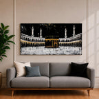 Panoramic artwork of the Kaaba at Masjid al-Haram in Mecca with black and gold accents surrounded by mosque arches and tall minarets against a dark night background.