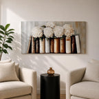 Panoramic still life painting of white hydrangea flowers arranged inside stacked vintage books with neutral beige and cream tones in a soft textured background.