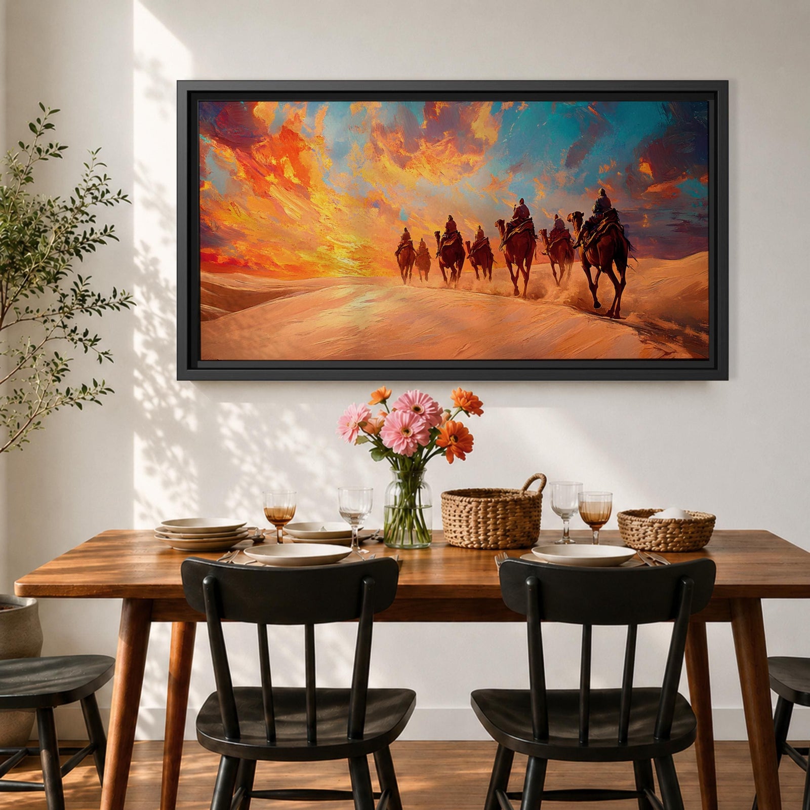Panoramic painting of a camel caravan traveling across golden desert dunes at sunset with riders silhouetted beneath a vibrant dramatic sky.