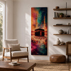 A tall narrow vertical depiction of the Kaaba in Mecca surrounded by a gathering of pilgrims, rendered in an abstract expressive style with bold layered brushwork, deep blues, warm oranges, and rich magenta tones blending into a textured composition that conveys movement, depth, and energy.