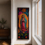 A tall narrow vertical depiction of Our Lady of Guadalupe with hands clasped in prayer, wearing a star covered mantle and framed by a radiant sunburst, surrounded by layered floral and botanical forms in a Mexican folk art style with rich contrasting tones and a dimensional textured composition.