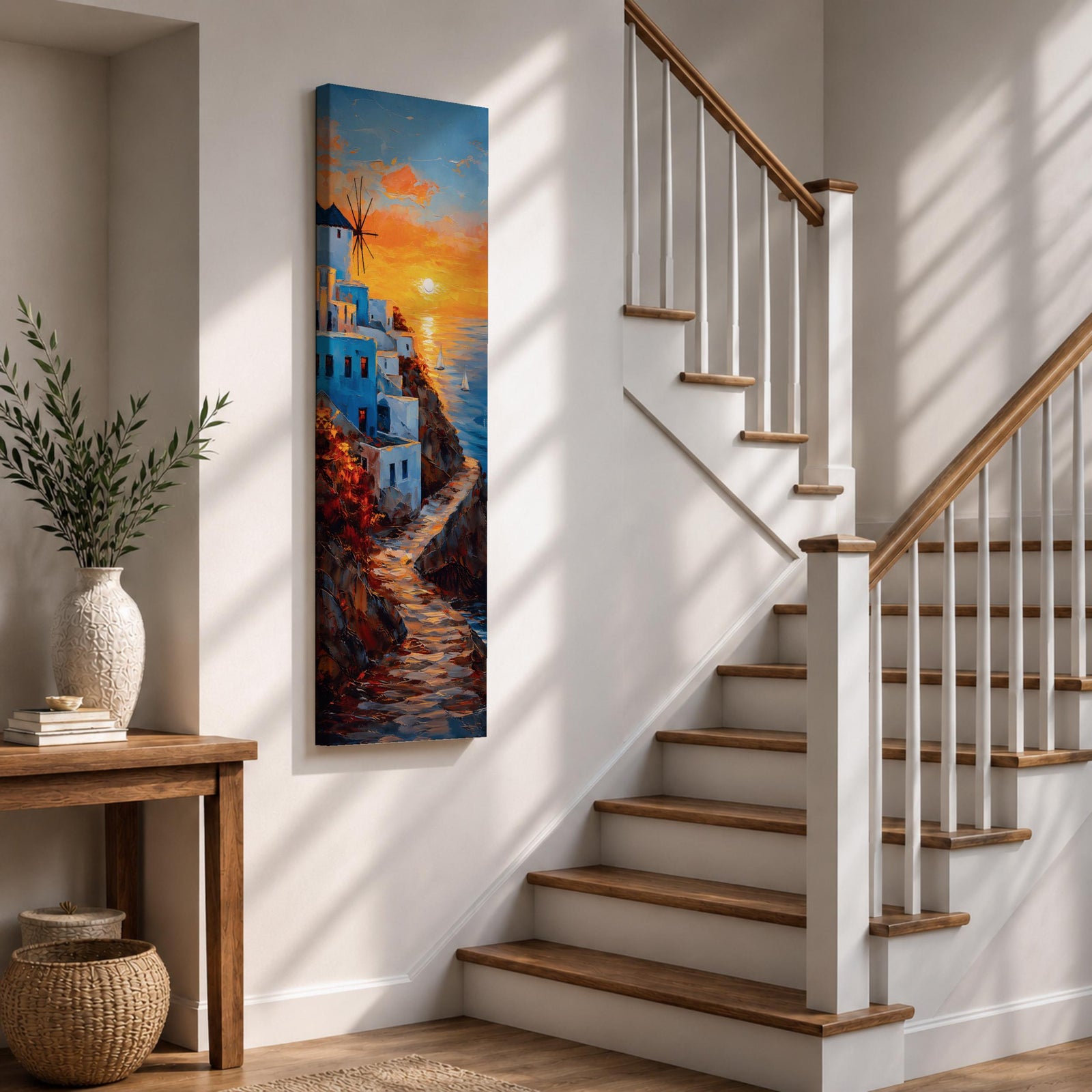A tall vertical painting depicts a Santorini coastal scene with whitewashed buildings perched along a cliffside, a winding stone path leading toward the sea, and a glowing sunset casting warm orange and gold light across the sky and water, with a windmill silhouette and small sailboats adding depth to the vibrant Mediterranean composition.
