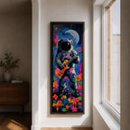 A tall vertical artwork shows an astronaut in a detailed space suit playing an electric guitar, set against a vivid cosmic backdrop with a glowing moon, deep blue sky, and splashes of neon pink, green, and orange paint, while bright flowers bloom at the base, blending surreal space imagery with street art style and bold expressive color.