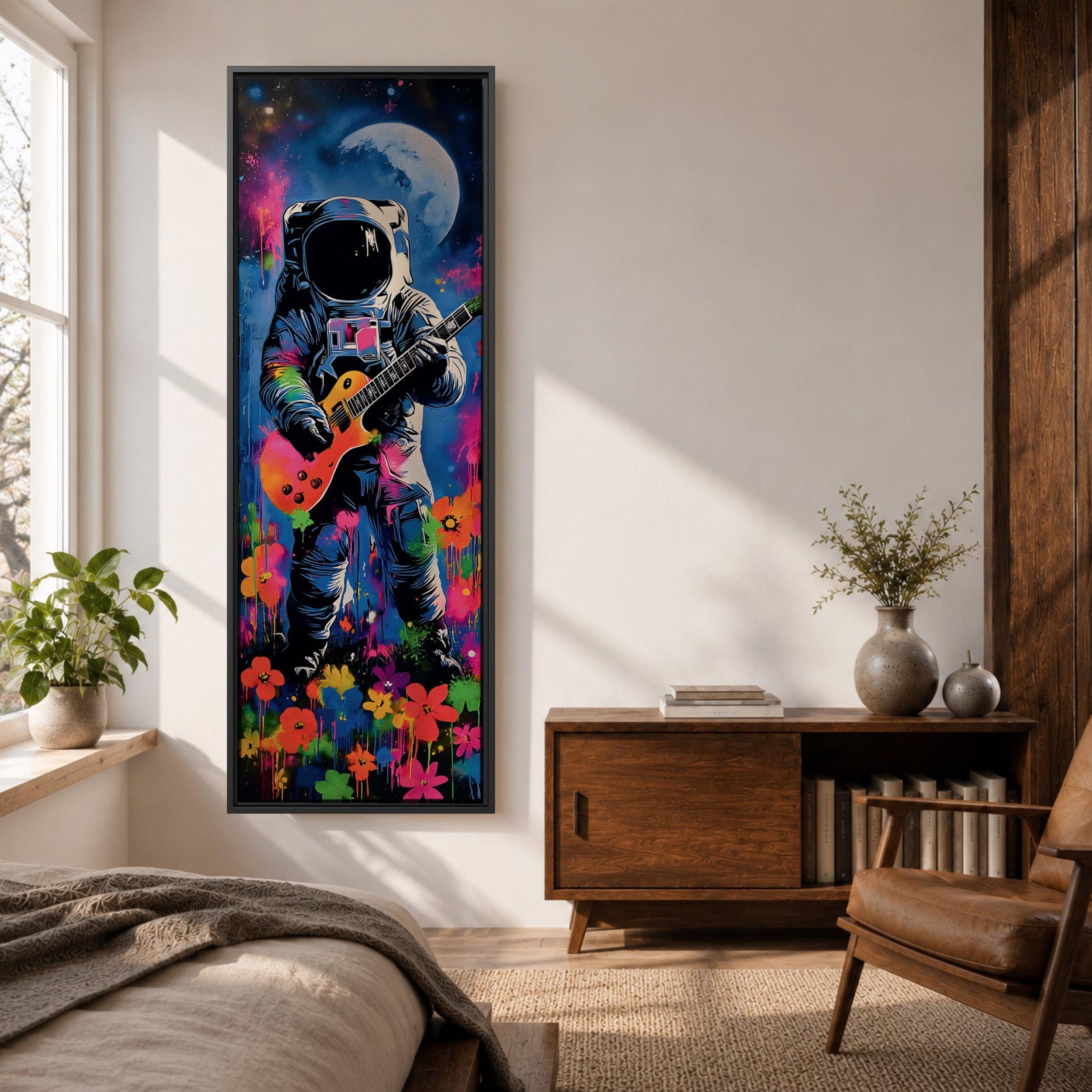 A tall vertical artwork shows an astronaut in a detailed space suit playing an electric guitar, set against a vivid cosmic backdrop with a glowing moon, deep blue sky, and splashes of neon pink, green, and orange paint, while bright flowers bloom at the base, blending surreal space imagery with street art style and bold expressive color.