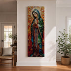 Long vertical stained glass style depiction of Our Lady of Guadalupe with hands clasped in prayer. She wears a green mantle decorated with stars and a red robe while radiant golden rays form a halo behind her, composed of colorful mosaic glass pieces forming a luminous devotional image.